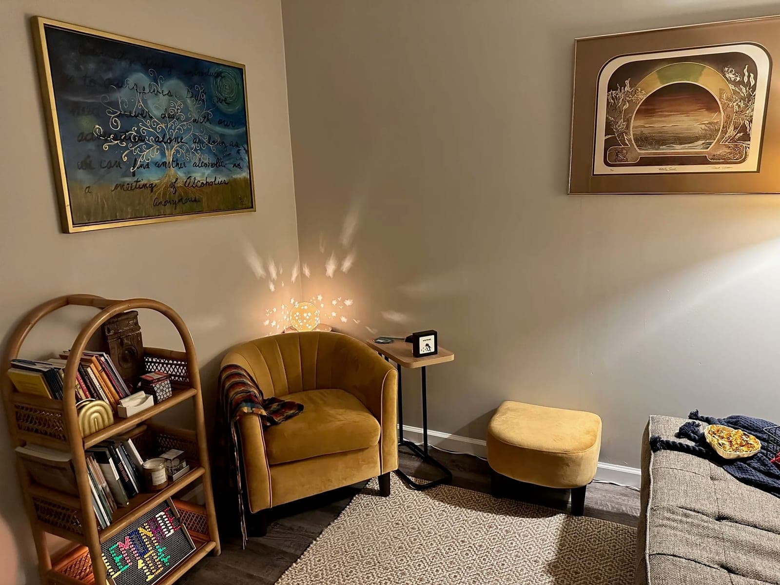 The counseling room at Pathways Mental Health, with a soft armchair, warm lamp light, a bookshelf, and a woven rug